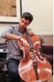  ??  ?? Iranian-Austrian cellist Kian Soltani performs during an interview with AFP at the Kennedy Center.