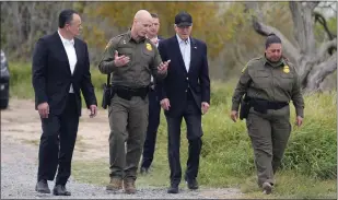  ?? EVAN VUCCI — THE ASSOCIATED PRESS ?? President Joe Biden, center, looks over the southern border, Thursday, Feb. 29, 2024, in Brownsvill­e, Texas. Walking with Biden are from l-r., Peter Flores, Deputy Commission­er, U.S. Customs and Border Protection, Jason Owens, Chief, U.S. Border Patrol and Gloria Chavez, Sector Chief, U.S. Border Patrol.