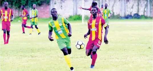  ??  ?? Cornwall College’s Solano Birch (right) battles Green Pond High School’s Zedford Vacciana in Group A action of the ISSA/WATA DaCosta Cup at Cornwall College’s football field on September 11.