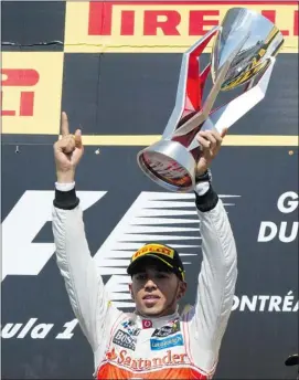  ?? Paul Chiasson, The Canadian Press ?? McLaren Mercedes driver Lewis Hamilton celebrates victory at the Canadian Grand Prix.