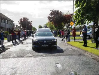  ??  ?? The hearse carrying the late Mossie Spillane (Kerry GAA steward) took a u turn to Spa Road, Tralee before going to the church for funeral service so his neighbours and friends could wish him goodbye. Photo Joe Hanley