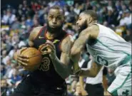  ?? ASSOCIATED PRESS ?? FILE - In this Feb. 11, 2018, file photo, Cleveland Cavaliers’ LeBron James (23) drives against Boston Celtics’ Marcus Morris (13) during the third quarter of a game in Boston.