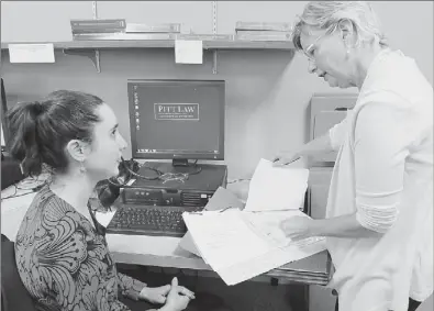  ?? Bob Donaldson/Post-Gazette. ?? Law professor Martha Mannix, right, reviews a case with law student Lea Lach at the University of Pittsburgh Elder Law Clinic.