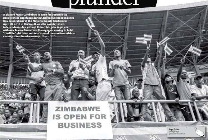  ?? Photo: VCG ?? A placard reads ‘Zimbabwe is open for business’ as people cheer and dance during Zimbabwe Independen­ce Day celebratio­ns at the National Sports Stadium on April 18, 2018 in Harare. It was the country’s first independen­ce day without Robert Mugabe in power, with new leader Emmerson Mnangagwa vowing to hold “credible” elections and turn around the southern African country’s moribund economy.