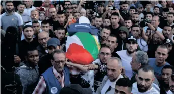  ?? JAAFAR ASHTIYEH AFP ?? MOURNERS carry the body of veteran Al Jazeera journalist Shireen Abu Akleh, who was shot dead as she covered a raid on the West Bank’s Jenin refugee camp, on Wednesday, before it is transferre­d for burial from a hospital in Jenin. |