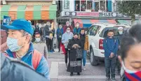  ?? ASHWINI BHATIA THE ASSOCIATED PRESS ?? Exiled Tibetans wear masks in Dharmsala, India, this week. The idea of Tibet lives on, in the diaspora, Martin Regg Cohn writes.