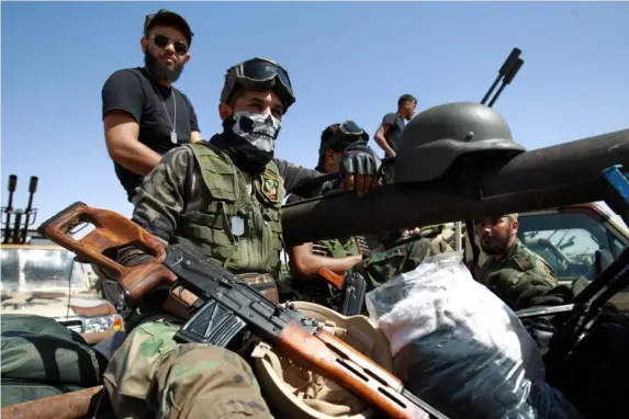  ?? (AFP/Getty) ?? Members of Libyan National Army gather in the city of Benghazi