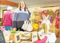  ?? N.F. Ambery / Hearst Connecticu­t Media ?? Karen Pavano, of Burlap Beautiful, shows off her homemade burlap bags, wreaths and Easter-themed wine-bottle holders at a past craft event in Winchester. This year, Winchester Grange will hold its 67th Annual Grange Fair, Flea Market at the Grange Hall. The area’s best fruits, vegetables, baked goods and local vendors will gather from 9 a.m. to 2 p.m.