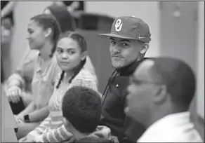  ?? Associated Press ?? Home grown: Norman North High School basketball star Trae Young is surrounded by family as he announces he will take his talents to the University of Oklahoma, in Norman, Okla. Kentucky and Kansas were in the running to sign Young, but he chose to stay...