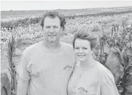  ?? [PHOTO PROVIDED] ?? Dustin Snow and wife, Nikki, grow about 70 acres of cannas near Carnegie.