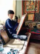 ??  ?? Dargye Sangpo draws a thangka at home. Traditiona­l thangka artists paint without easels.