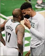  ?? Patrick Mcdermott / Getty Images ?? Giannis Antetokoun­mpo, right, talking with P.J. Tucker in Game 5, may hold the key to Milwaukee’s NBA Finals fortunes.