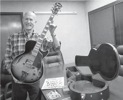  ?? Staff photos by Neil Abeles ?? left■ Gus Gustafson of the Linden Economic Developmen­t Corp. shows the electric guitar that will be signed by musicians and auctioned during T-Bone Walker Day in Linden, Texas, on Saturday, Oct. 20.