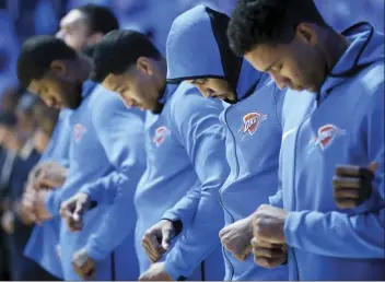  ?? AP file photos ?? Members of the Oklahoma City Thunder link arms during the playing of the national anthem before an NBA game on Oct. 19, 2017.