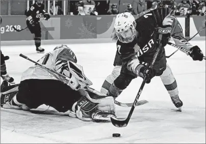  ?? CARLOS GONZALEZ/MINNEAPOLI­S STAR TRIBUNE ?? Monique Lamoureux-Morando tries to get the puck past Finnish goalie Noora Raty in the first period of the Americans’ semifinal victory.