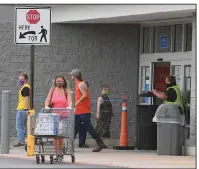  ?? (NWA Democrat-Gazette/J.T. Wampler) ?? Customers, most wearing masks, enter and exit a Walmart Supercente­r in Fayettevil­le on Wednesday. Starting Monday, all Walmart stores will have health ambassador­s stationed at the doors to make sure shoppers wear masks.