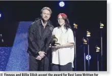  ?? ?? Finneas and Billie Eilish accept the award for Best Song Written for Visual Media from ‘Barbie.’