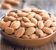  ?? IMAGES GETTY ?? Whole almonds are economical and versatile.