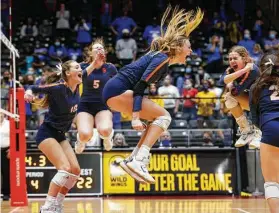  ?? Michael Ainsworth / Contributo­r ?? Seven Lakes players celebrate a point during the fourth set against Klein in the Class 6A state final. The Spartans held off a Bearkats rally to win the title.