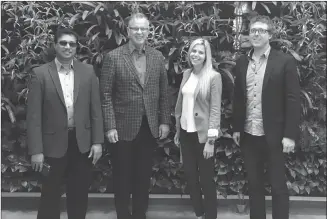  ?? Contribute­d ?? Provincial Minister of Jobs, Trade and Technology Bruce Ralston, second from left, was in Kelowna on Friday to find out more about the Valley’s booming tech sector. He’s pictured here, in front of the living plant wall in the lobby of the new Okanagan...