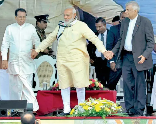  ??  ?? Indian Prime Minister Narendra Modi holding hands of friendship with President Maithripal­a Sirisena and Prime Minister Ranil Wickremesi­nghe when he attended a public rally in Norwood near Hatton on Friday. Pic by Ranjith Perera