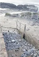  ??  ?? The ferocious waves washed rocks up onto the seafront and steps in Porthcawl and damaged the Jennings building