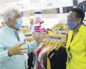  ??  ?? Michael Ammar Jr (left) in discussion with Beatrice Duhaney, store manager at Ammars’ Sovereign branch.