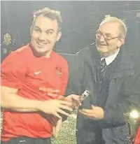  ??  ?? ●● Sam Williamson collects his man of the match award after the Stockport FA Senior Cup Final