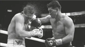  ?? JOHN LOCHER/AP ?? DMITRY BIVOL (RIGHT) OF KYRGYZSTAN, throws a punch against Canelo Alvarez, of Mexico, during a light heavyweigh­t title boxing match on Saturday in Las Vegas.