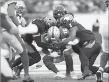  ?? Canadian Press photo ?? Winnipeg Blue Bombers quarterbac­k Matt Nichols, centre, is sacked by Calgary Stampeders during first half CFL West Final football action in Calgary, Sunday.