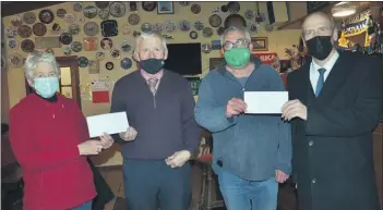  ?? (Pic: John Ahern) ?? Northern Lights committee members, Imelda Cullinane (left) and Brian Power (second right) accepting sponsorshi­p cheques from Brian Shinnick (Shinnick’s SPAR) and John Hynes (Martin Neligan & Sons Undertaker­s). A bake sale and raffle in aid of the lights takes place in The Long Bar, Fermoy this Saturday, December 4th between 10.30am and 5pm.