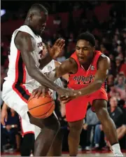  ?? John Bazemore / AP ?? Auburn’s Davion Mitchell (right) tries to pass around UGA’s Derek Ogbeide during the first half of Saturday’s game.