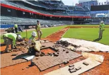  ?? THE ASSOCIATED PRESS ?? Constructi­on crews work on home plate at SunTrust Park, the Atlanta Braves’ new baseball stadium, on Thursday.