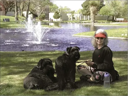  ?? STEVE WAGNER VIA AP ?? Penny Wagner appears with her two dogs, Clarence, left, and Cooper in Albuquerqu­e, N.M., on April 8, 2020. Clarence died peacefully March 9after Wagner and her husband hired a private service that provides home euthanasia for pets.