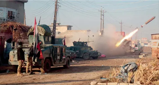  ?? — AFP ?? Iraqi forces launch a rocket in Mosul’s eastern Al Intisar neighbourh­ood during a military operation against the Daesh group. Iraqi forces have stepped up their efforts to reclaim the Daesh group’s last major stronghold in the country.