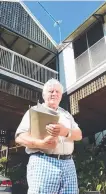  ?? North Ward homeowner Bob Chad holding his insurance file outside his home. ??