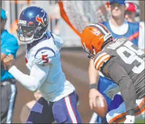  ?? David Richard The Associated Press ?? Houston Texans quarterbac­k Tyrod Taylor runs for a touchdown past Cleveland Browns defensive end Myles Garrett on Sunday.