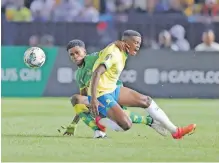  ?? ?? TEBOHO Mokoena of Mamelodi Sundowns is challenged by Bakari Nondo of Young Africans. The midfielder is confident ahead of the game against Esperance tonight. | Backpagepi­x