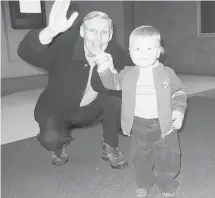  ??  ?? Down the generation­s: Brian Barry and the grandson who takes after his reading and whistling abilities.