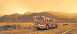  ?? ERIC THAYER/THE NEW YORK TIMES ?? A firetruck monitors a fire Thursday in Juniper Hills, Calif.