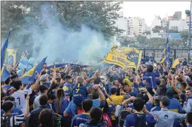  ?? PAULA RIBAS / GETTY IMAGES ?? Fans of Boca Juniors gather to bid farewell to Boca Juniors players who travel to Madrid to play River Plate in the Copa CONMEBOL Libertador­es second leg final Tuesday at Plaza Lezama in Buenos Aires, Argentina.