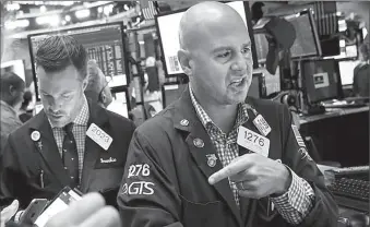  ?? -AP ?? Traders work on the floor of New York stock Exchange.