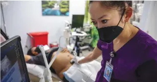  ?? (Evelyn Hockstein/Reuters) ?? DR. SHELLY TIEN performs an ultrasound on a patient at Planned Parenthood in Jacksonvil­le, Florida.