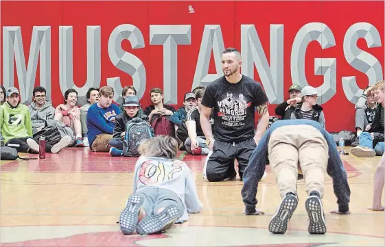  ?? JASON BAIN EXAMINER ?? Boxing champ Cody Crowley leads CSS students through an exercise Monday.