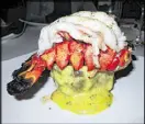  ?? CONTRIBUTE­D BY TRACEY TEO ?? The wet-aged filet mignon smothered in bearnaise sauce and topped with a lobster tail is a popular entree at the Ocean Room at the Sanctuary.