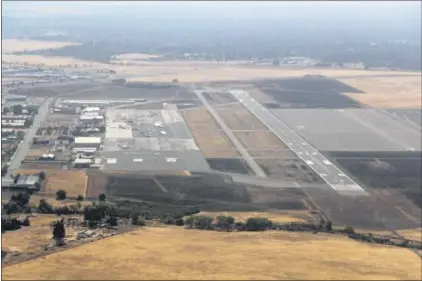  ?? JASON HALLEY — ENTERPRISE-RECORD FILE ?? This 2012photo shows the layout of the Chico Municipal Airport, looking south, with Taxiway A running between Runway 31R and the airport industrial park to the left.