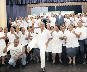  ?? | THEMBA MNGOMEZULU ?? NURSES celebrate with KwaZulu-Natal Health MEC Sibongisen­i Dhlomo, centre, after they were inducted into the department.