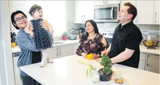  ?? CHRISTINA RYAN ?? The spaciousne­ss of their new kitchen allows 11-year-old Santiago Olivares-Escorcia and his one-year-old sister Hadassah Viloria-Escorcia to enjoy quality time with their parents Massiel Escorcia-Caballero and Cesar Viloria-Petit.