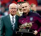  ??  ?? Record breaker… Bobby Charlton presented Rooney with a Golden Boot to honour his England goal record