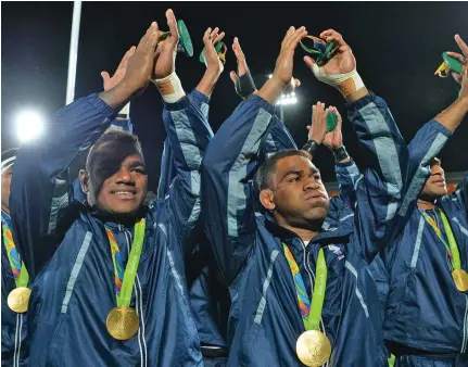  ?? Photo: World Rugby. ?? Team Fiji men’s rugby 7s team (left-right0 Josua Tuisova, Vatemo Ravouvou and Jasa Veremalua after winning the gold medal at the 2016 Olympic Games in Rio de Janeiro, Brazil.